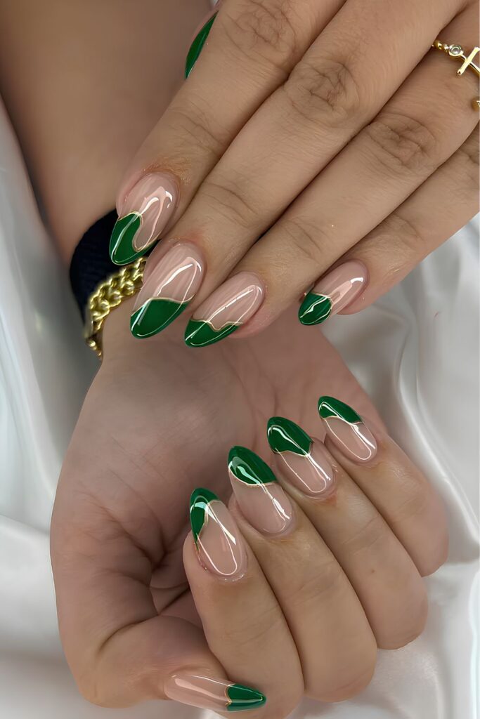 Close-up of almond nails with a green French design
